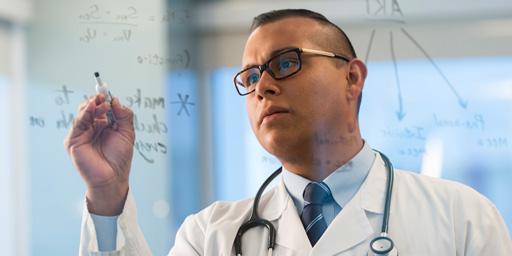 Mayo Clinic physician drawing on whiteboard